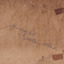 Rear of an aged photograph. Colour is a dark brown with some water damage visible.