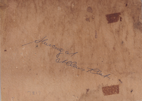 Rear of an aged photograph. Colour is a dark brown with some water damage visible.