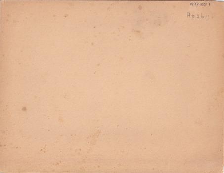 Rear of an aged photograph. Colour is tan with some dark age spots visible.