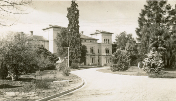 Obverse of a postcard depicting the front façade of the Mayday Hills Asylum and gardens