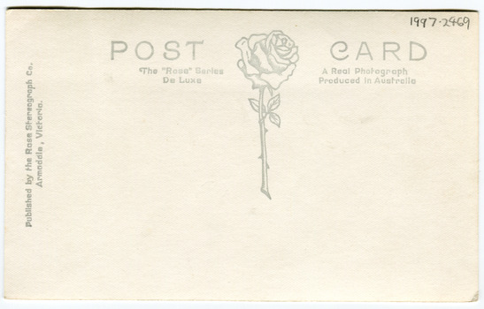 Reverse of a postcard depicting a large rose in the center of the card