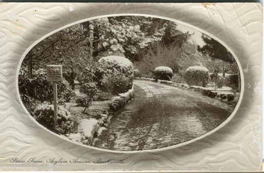 Obverse of a postcard depicting Mayday Hills with snow