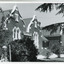 Group of buildings close together - gardens in front. On one building is a sign over the door: "Ovens & Murray Home"
