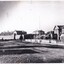 A black and white photograph of Ford street, Beechworth. In the background is the old Gaol with the Telegraphs Office, Gold Wardens and Courthouse Office on the right.