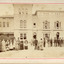 Out front of the Beechworth mental asylum administration building is twenty-eight staff members divided by gender with females on the left and males on the right. There is a child in the center 