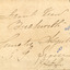 On the back of the photograph where a child sitting in a horse drawn carriage surrounded by eight people in front of the Beechworth Mental Asylum's administration building is original details about location and date of the photograph including a signature  