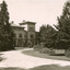 A sand pathway featuring manicured gardens on either side leading towards the Beechworth Mental Asylum administration building