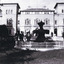 View of the Beechworth Mental Asylum administration building with fountain in foreground. Three men and a small boy to the left of the fountain.