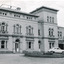 Rectangular black and white photograph of Beechworth Mental Hospital  (Mayday Hills) facing towards the right hand side of the administrative building with three cars parked in driveway turning circle in the foreground.