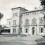 Rectangular black and white photograph of Beechworth Mental Hospital  (Mayday Hills)  facing towards the left hand side of the administrative building with three cars parked in driveway turning circle in the foreground.