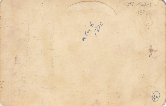 Rear of a photograph with writing in pencil and blue pen