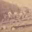 Four miners standing in mining sluice  at Three Mile Goldfields
