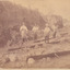 Four miners standing in mining sluice  at Three Mile Goldfields