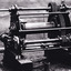 cropped black and white photograph of gold mining machinery.