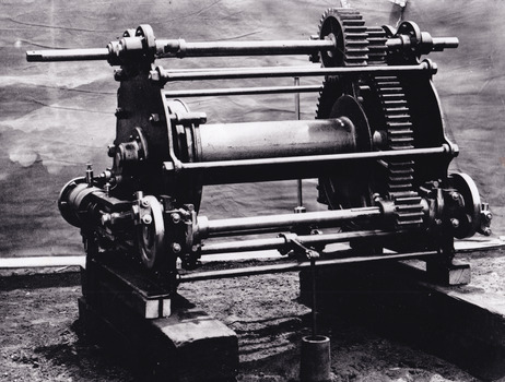cropped black and white photograph of gold mining machinery.