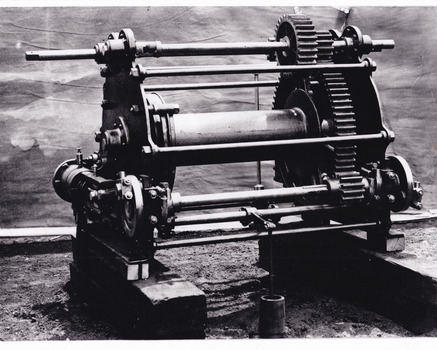 Black and white photograph shows a piece of gold mining machinery. 