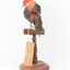 Taxidermy specimen of a male Scarlet Tanager standing on a wooden mount.