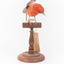 Taxidermy specimen of a male Scarlet Tanager standing on a wooden mount.