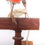 Taxidermy specimen of a male Scarlet Tanager standing on a wooden mount.