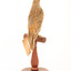 Rufous Songlark sitting on a wooden perch facing forward