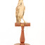 Rufous Songlark sitting on a wooden perch facing forward