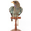 Dollarbird standing on a wooden mount facing forward. 