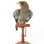  Dollarbird standing on a wooden mount facing forward. 