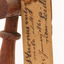 A close up of a swing-tag on a bird's leg (see transcription). A second swing-tag can be seen behind it.