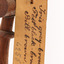 A close up of a swing-tag on a bird's leg (see transcription). A second swing-tag can be seen behind it.