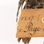 A torn half of a swing-tag (see transcription)