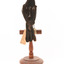 Red-winged Blackbird / Red-winged Starling standing on a wooden mount facing back 