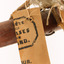 Close up of paper swing tag - half of a stamp - unintelligible text