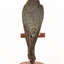 Australian Hobby perching on wooden stand facing back