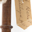 Barn Owl mounted on wooden perch pedestal with close-up view of paper swing tag (see transcription). 