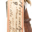 Ural Owl mounted on wooden perch pedestal with swing tag. Close-up view of paper swing tag attached to lower right leg (see transcription).