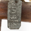 Ural Owl mounted on wooden perch pedestal with swing tag. Close-up view of metal swing tag attached to lower right leg (see transcription).