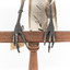 Grey Currawong/grey crow standing on wooden perch - closeup of claws on perch