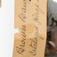 Close-up of swing tag attached to brown falcon  (see transcription)
