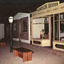 Colour photograph of indoor museum display showing recreated heritage street scene with shopfronts, lamp posts and benches