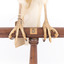 White Goshawk standing crouched on a wooden perch