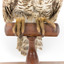 Powerful Owl standing on wooden mount close-up