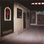 Coloured photograph containing a street of shops. Includes a saloon and hotel on the left, with a barber shop pole on the right of the image.