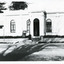 Black and white photograph of the front of the Burke Museum, with a sign out the front.