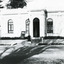 Black and white photograph of the front of the Burke Museum, with a sign out the front.