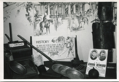 A black and white photograph with a white boarder of a historical exhibition display.