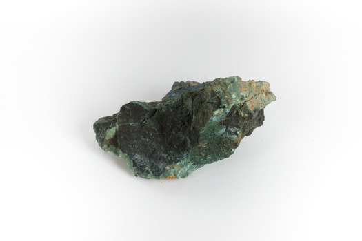 A hand-sized solid mineral specimen in shades of blue, green, and yellow