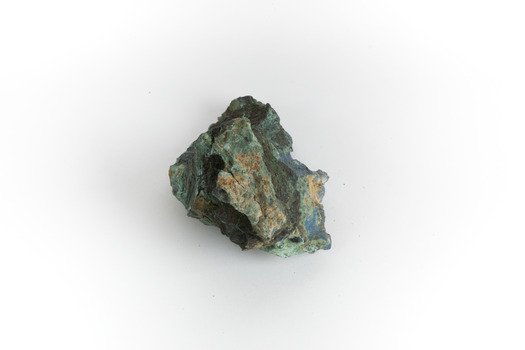A hand-sized solid mineral specimen in shades of blue, green, and yellow