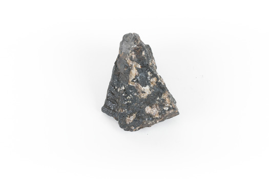 a hand sized solid mineral specimen in black with shades of beige