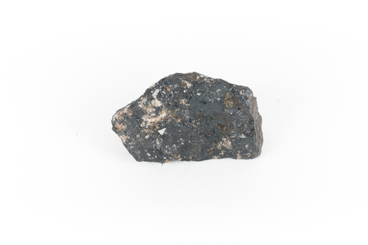 a hand sized solid mineral specimen in black with shades of beige
