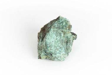 A solid cube-like mineral specimen in shades of green, brown and grey